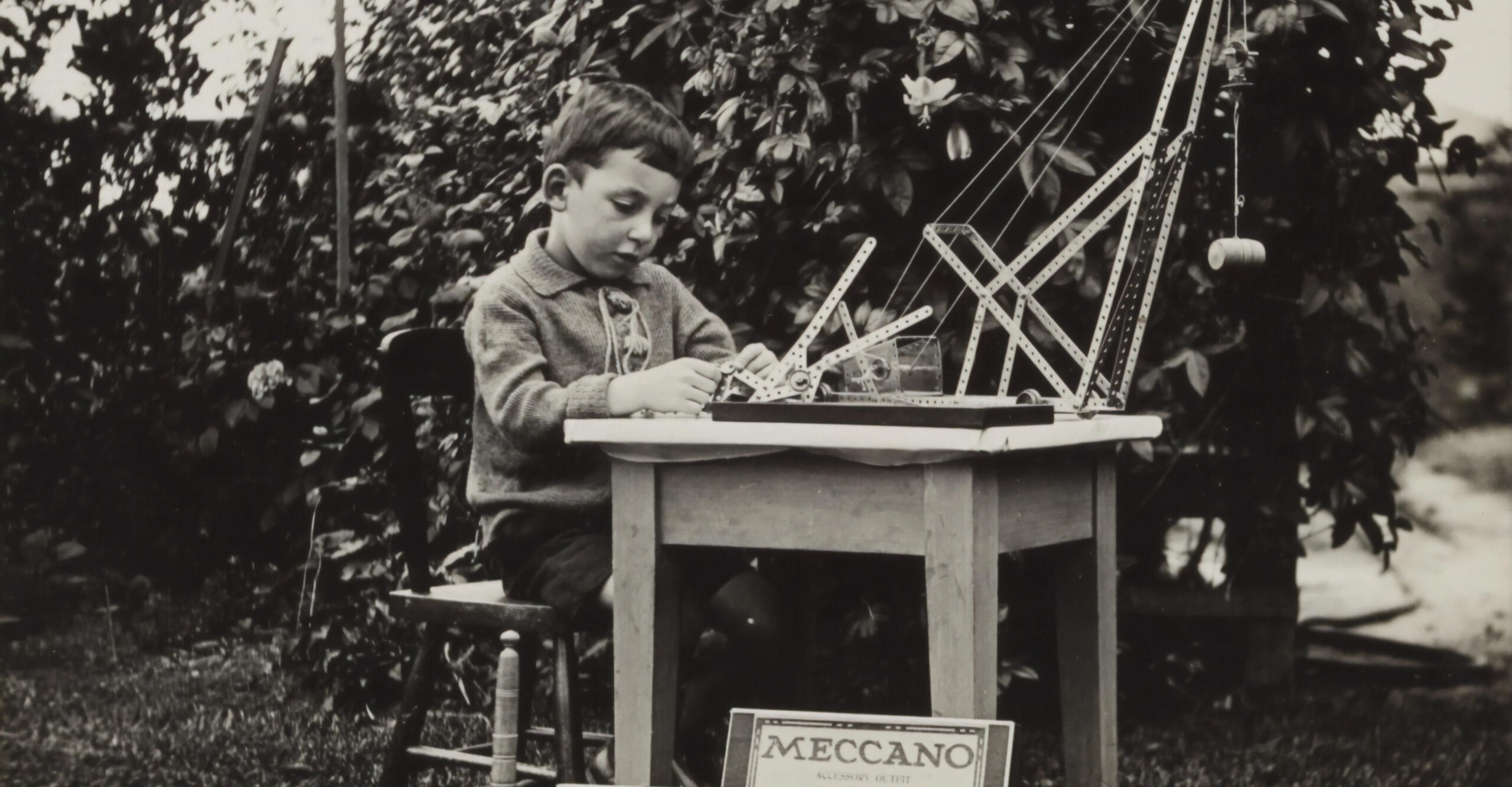 historical photo of a boy with meccano in the garden