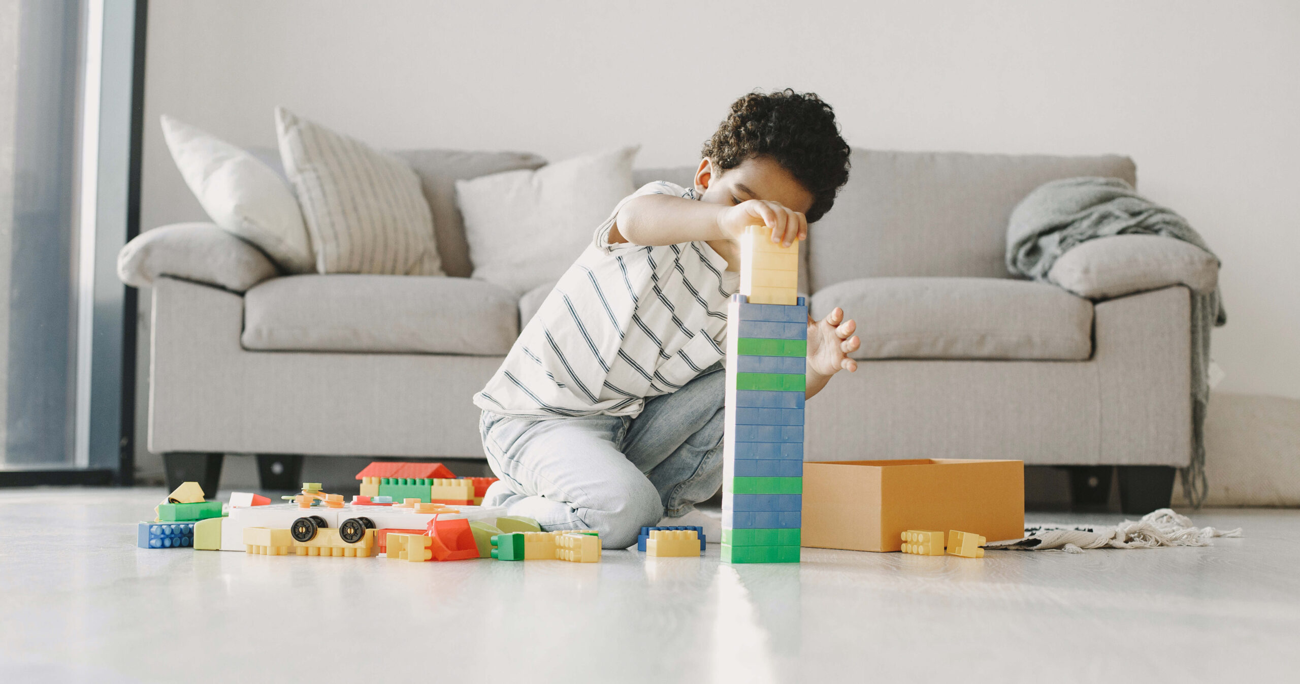 a child building a tower of blocks