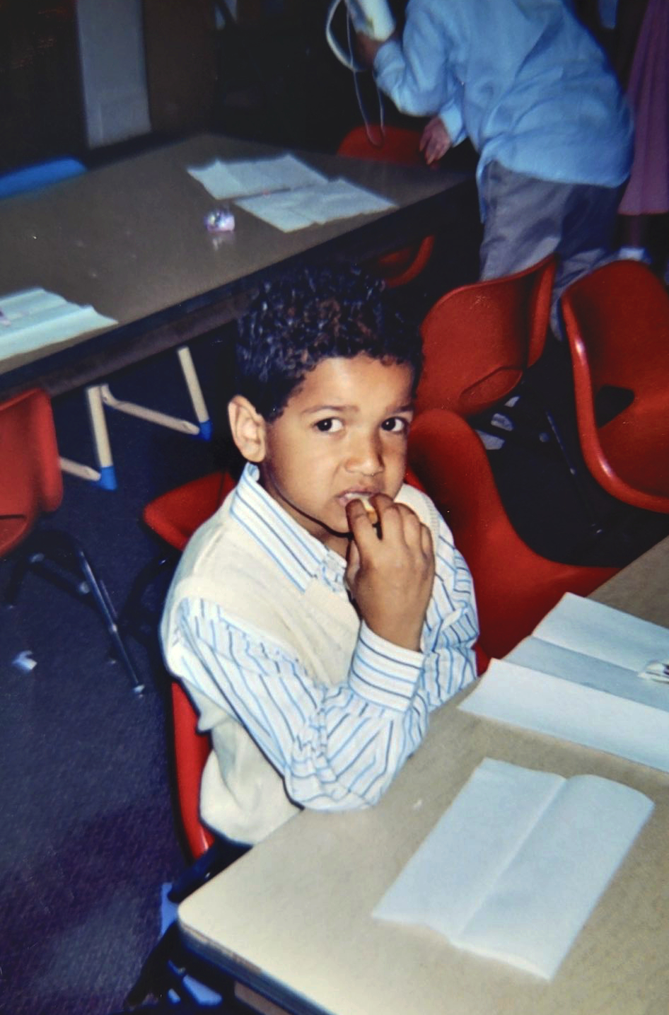 a child sitting at a desk in school