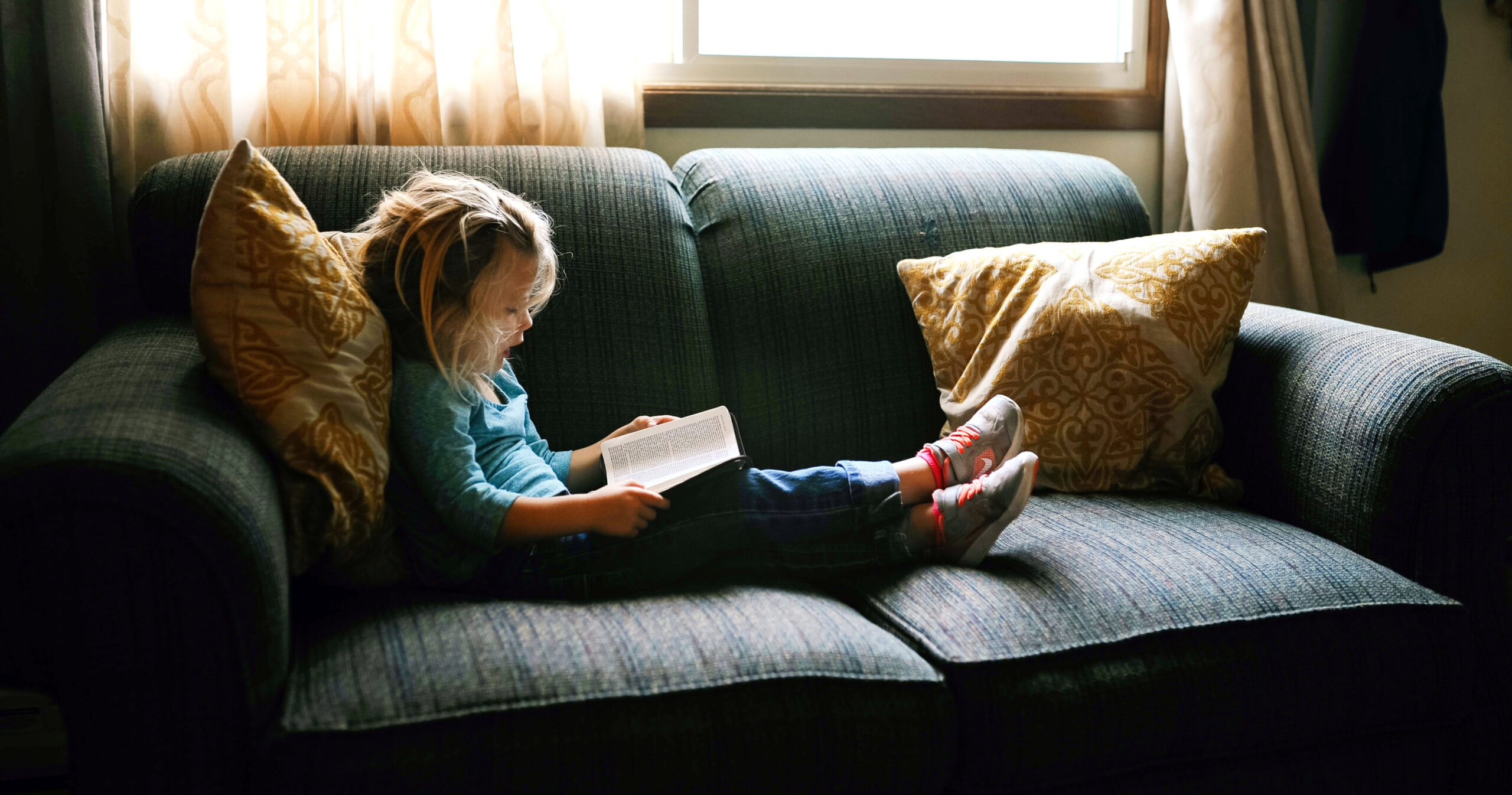 a child reading on the couch