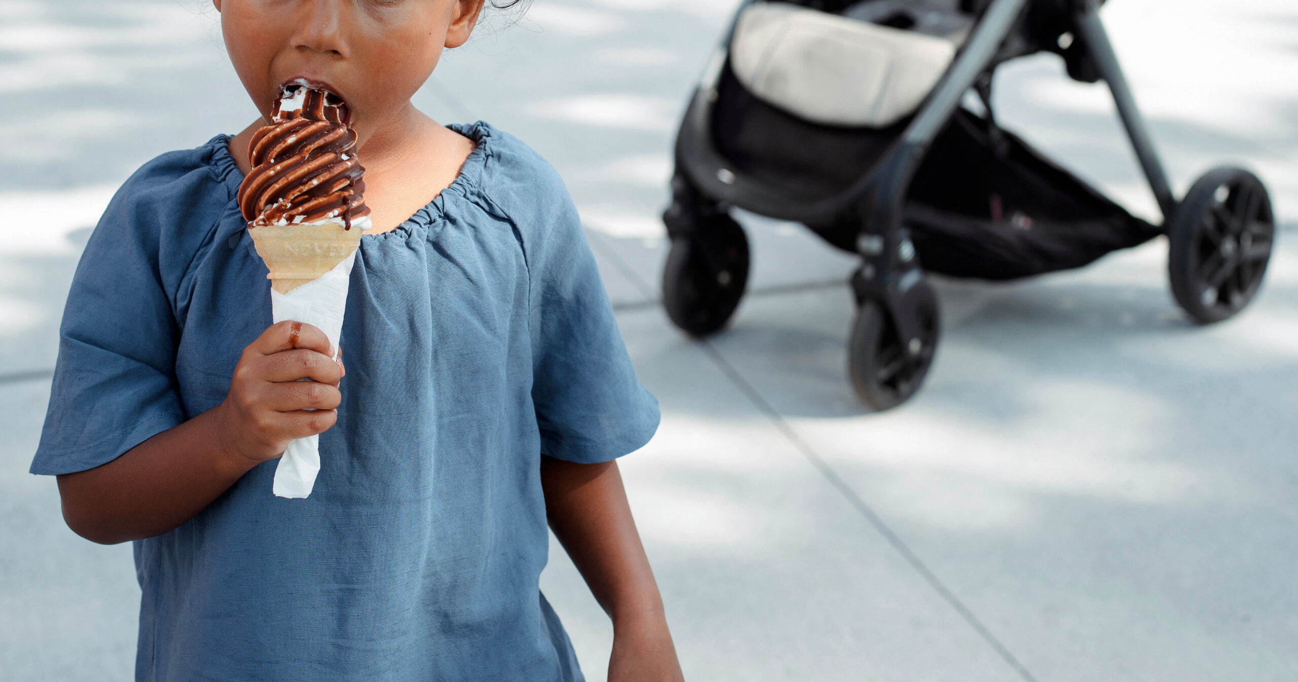 a child eating a large ice cream
