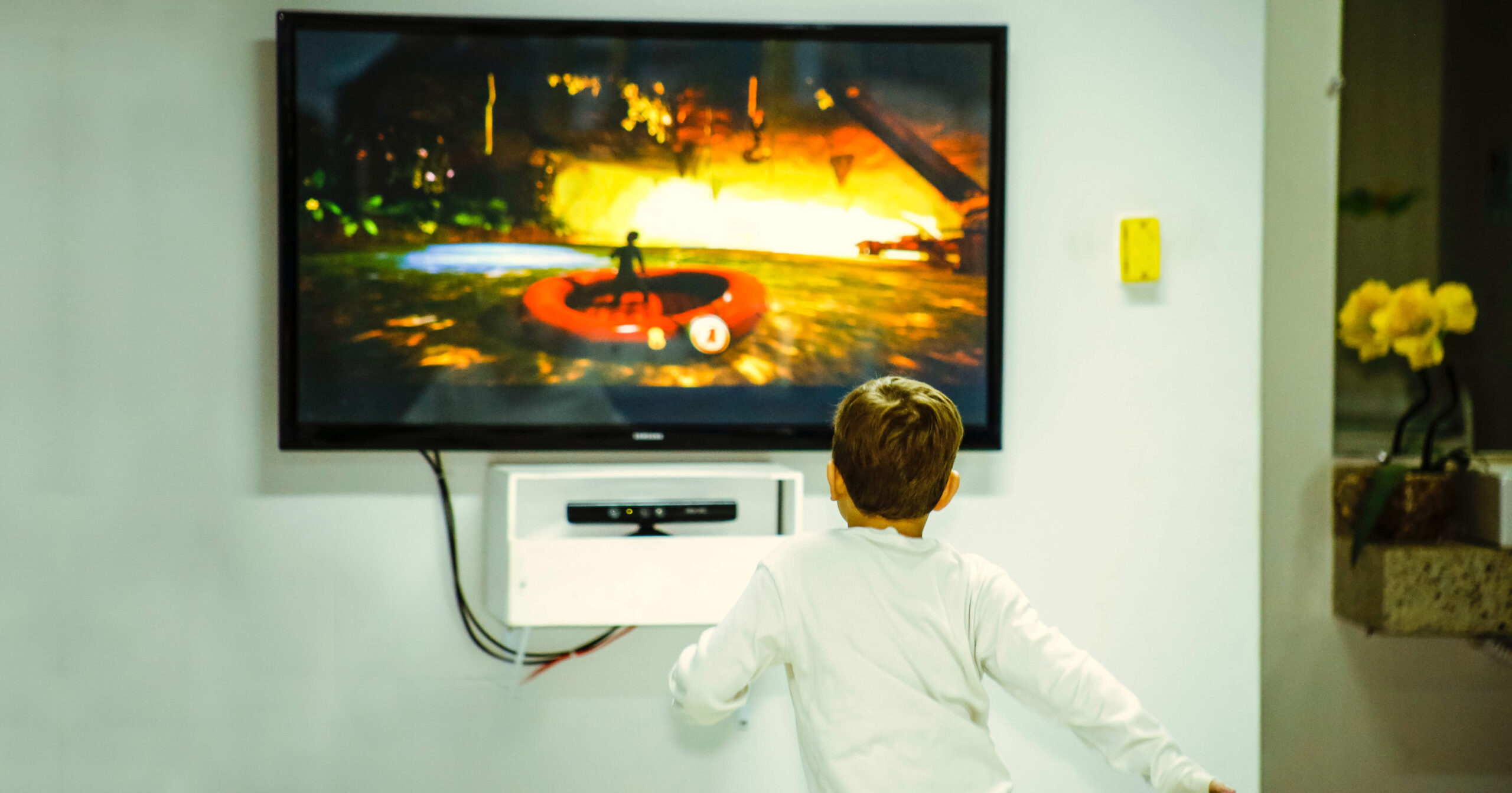 a child standing watching TV