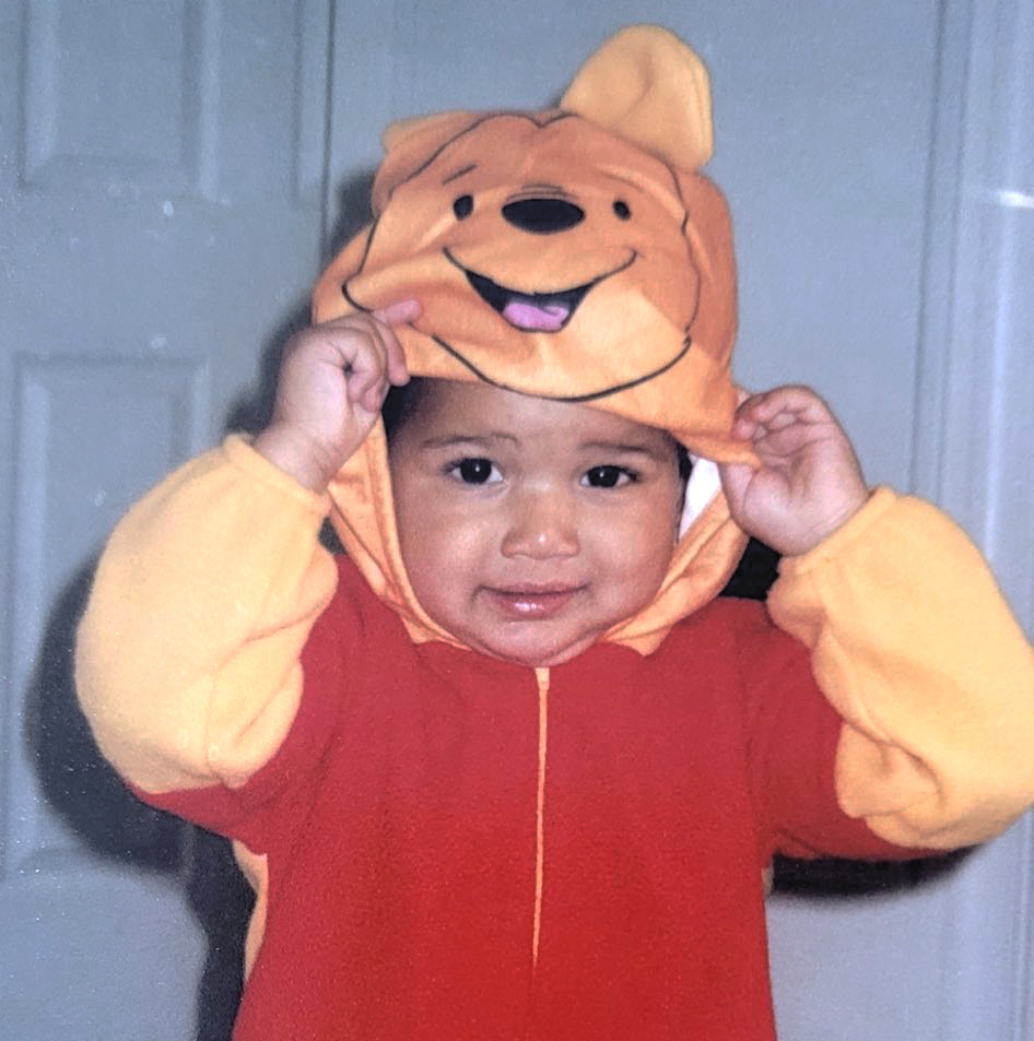 a child wearing a Pooh costume