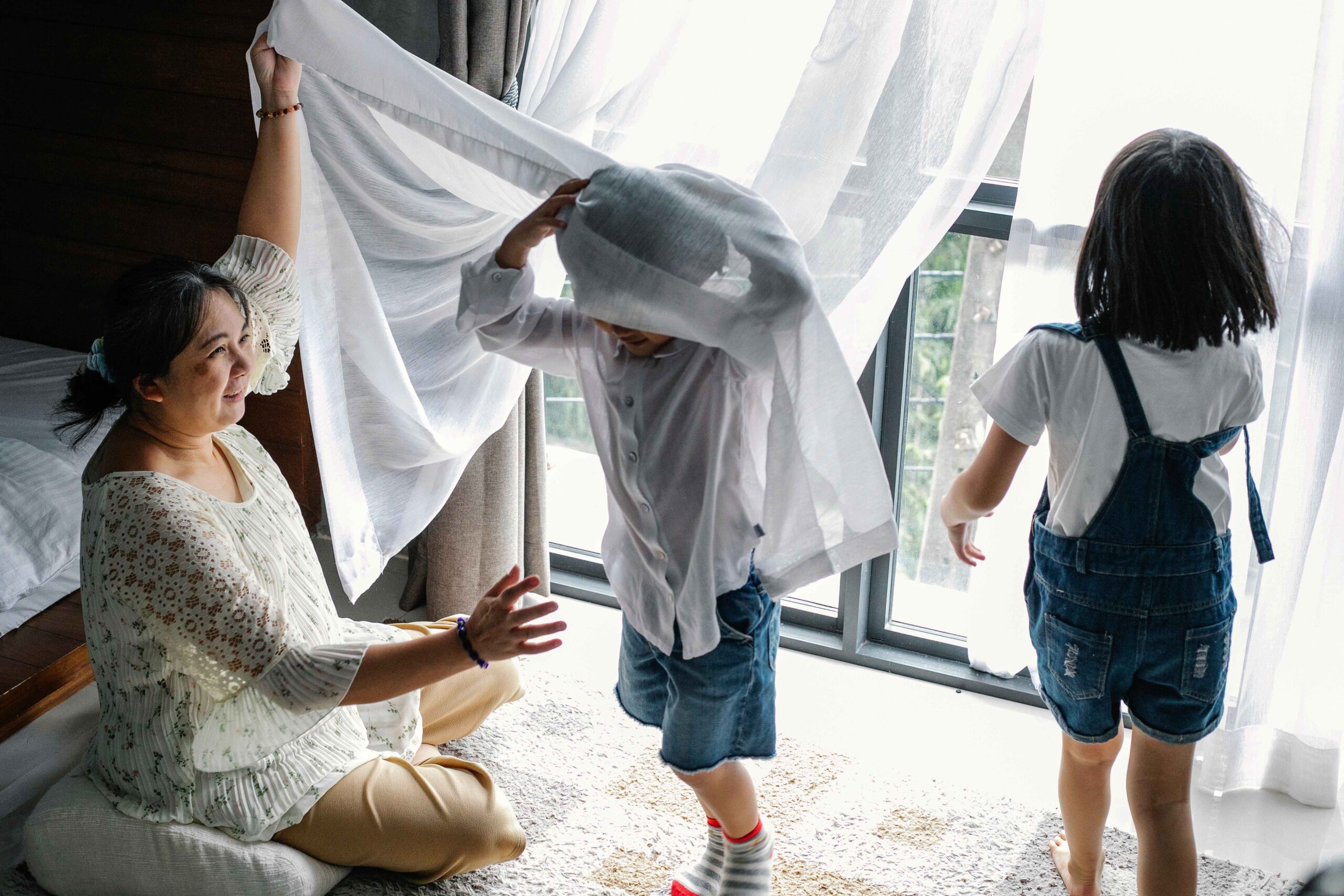 children playing in net curtains