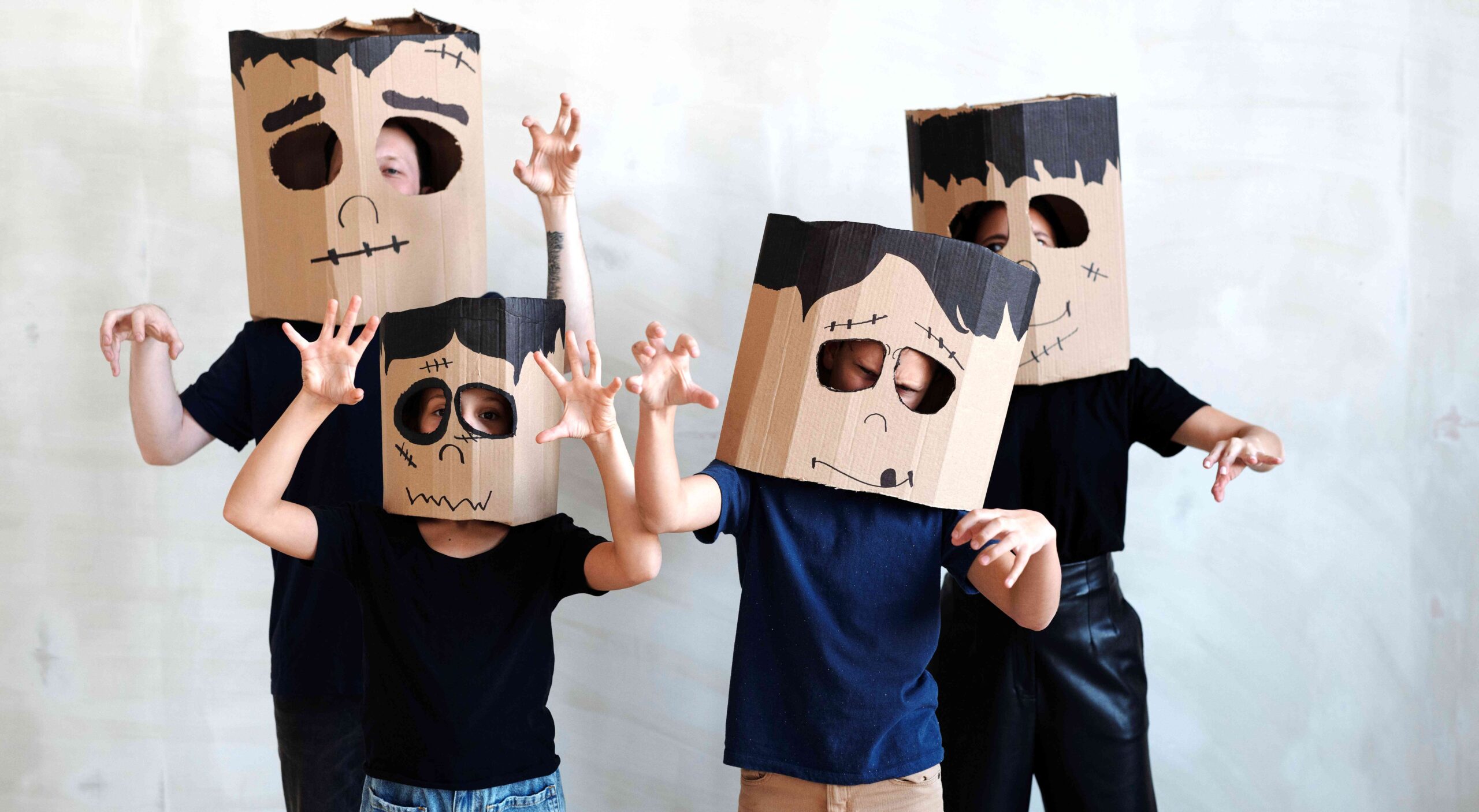 children wearing cardboard box masks on their heads