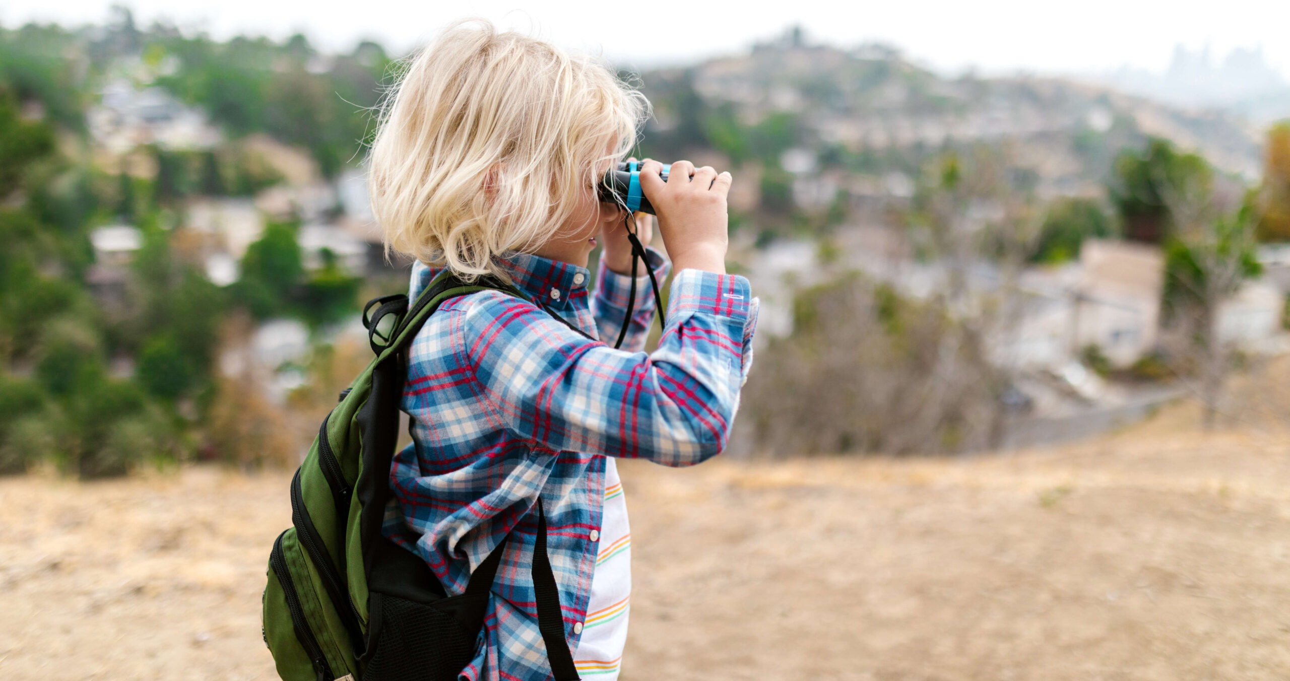 a child looking through binoculars