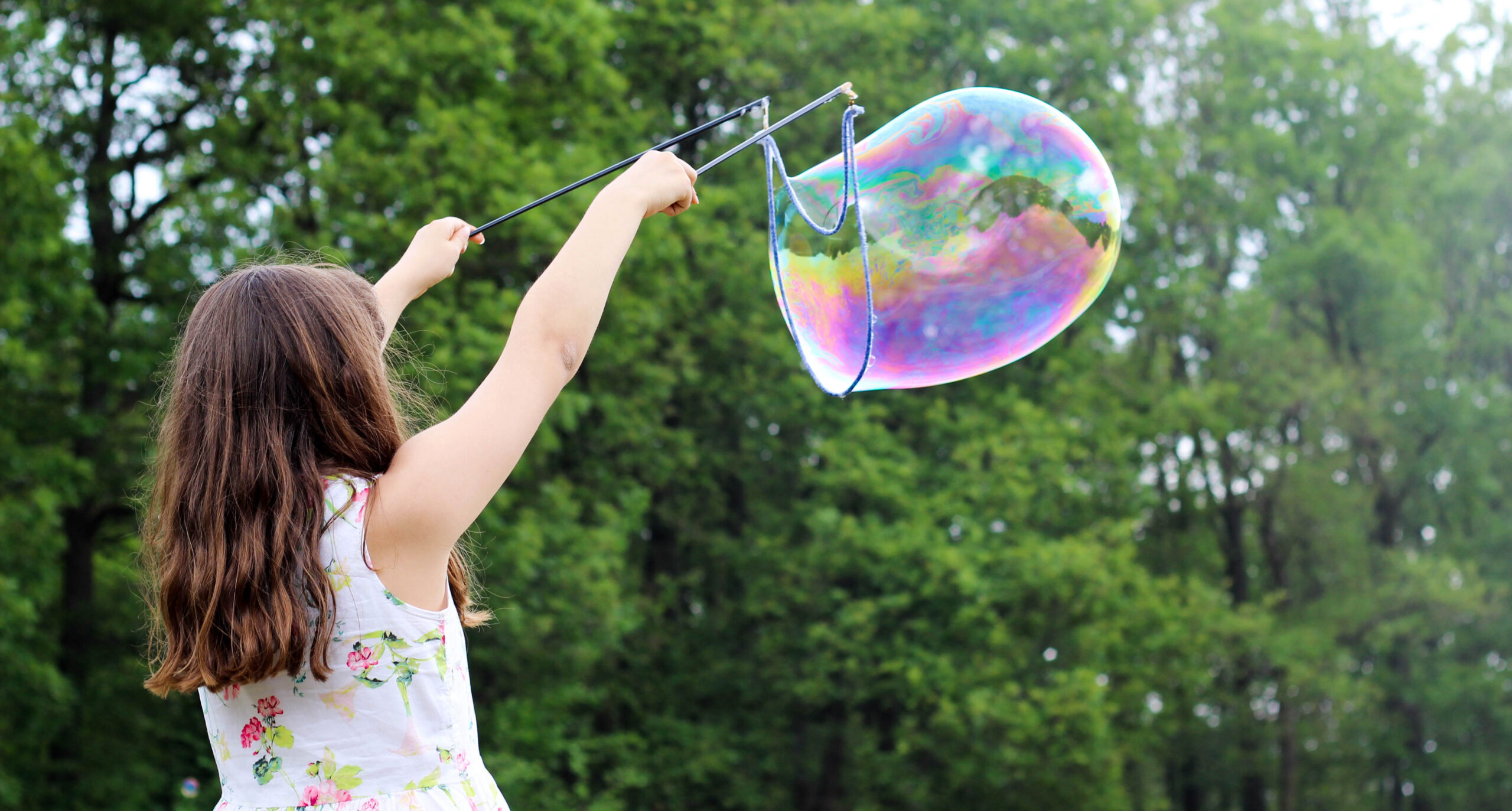 a child blowing a huge bubble