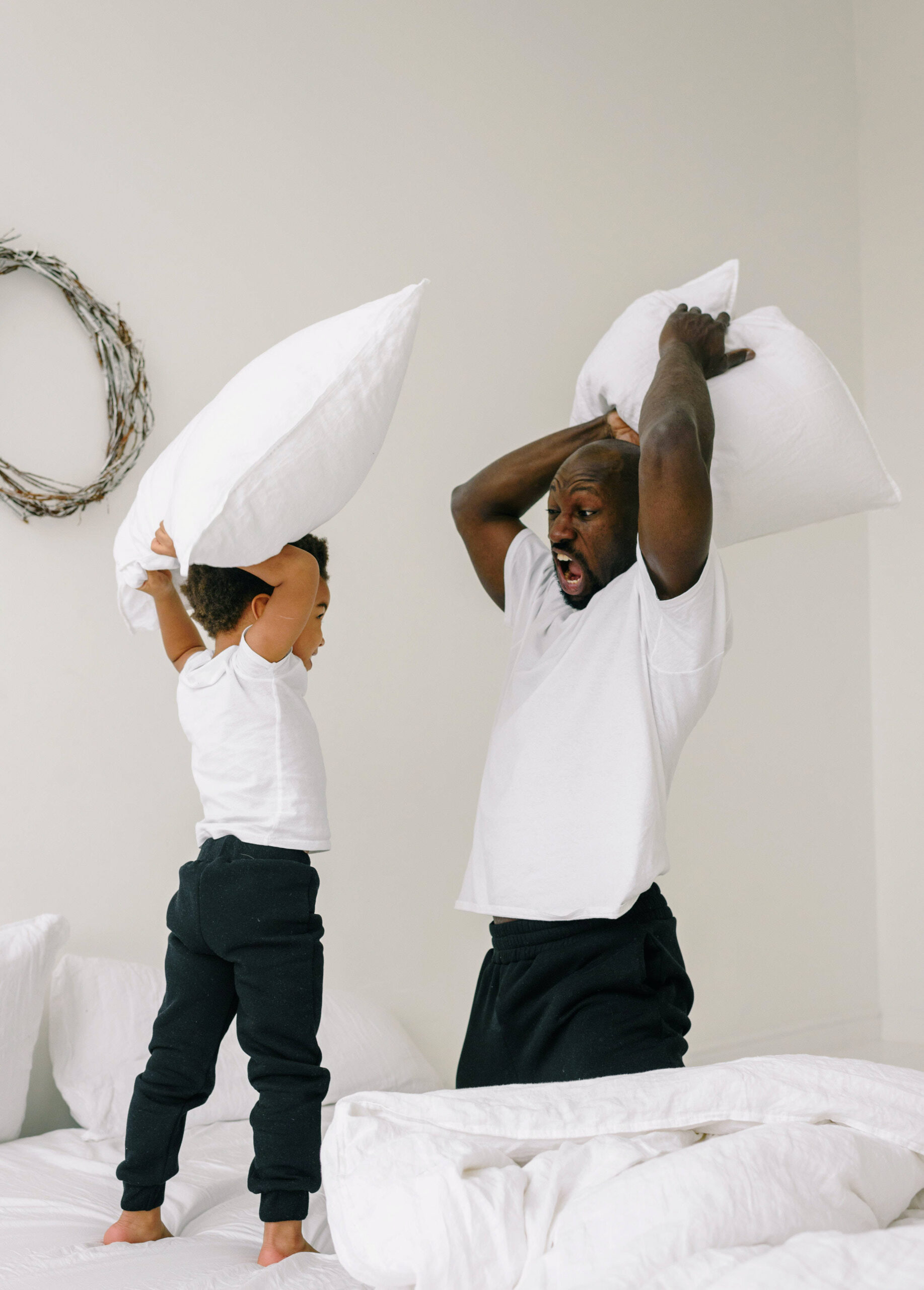 Father and son having a pillow fight