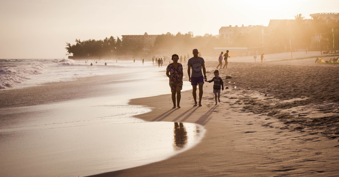 a family walking along the shoreline