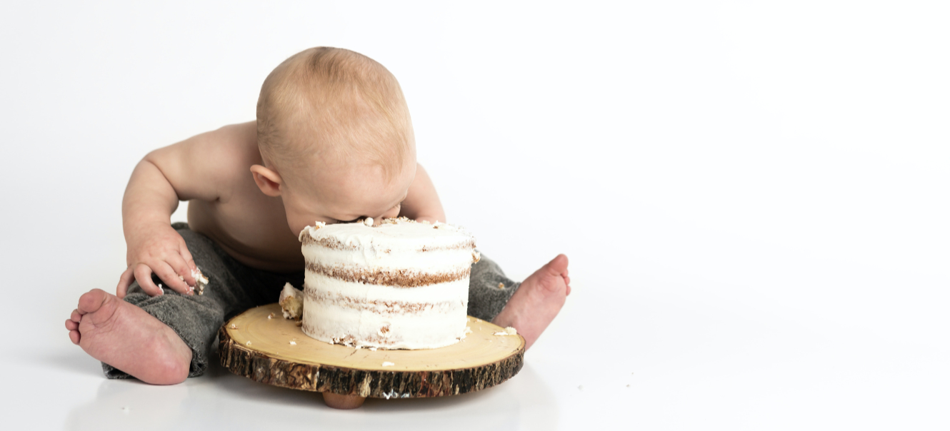 a baby with head in cake