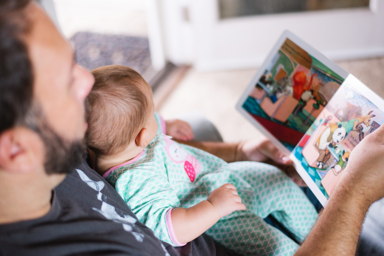 a parent reading to a baby