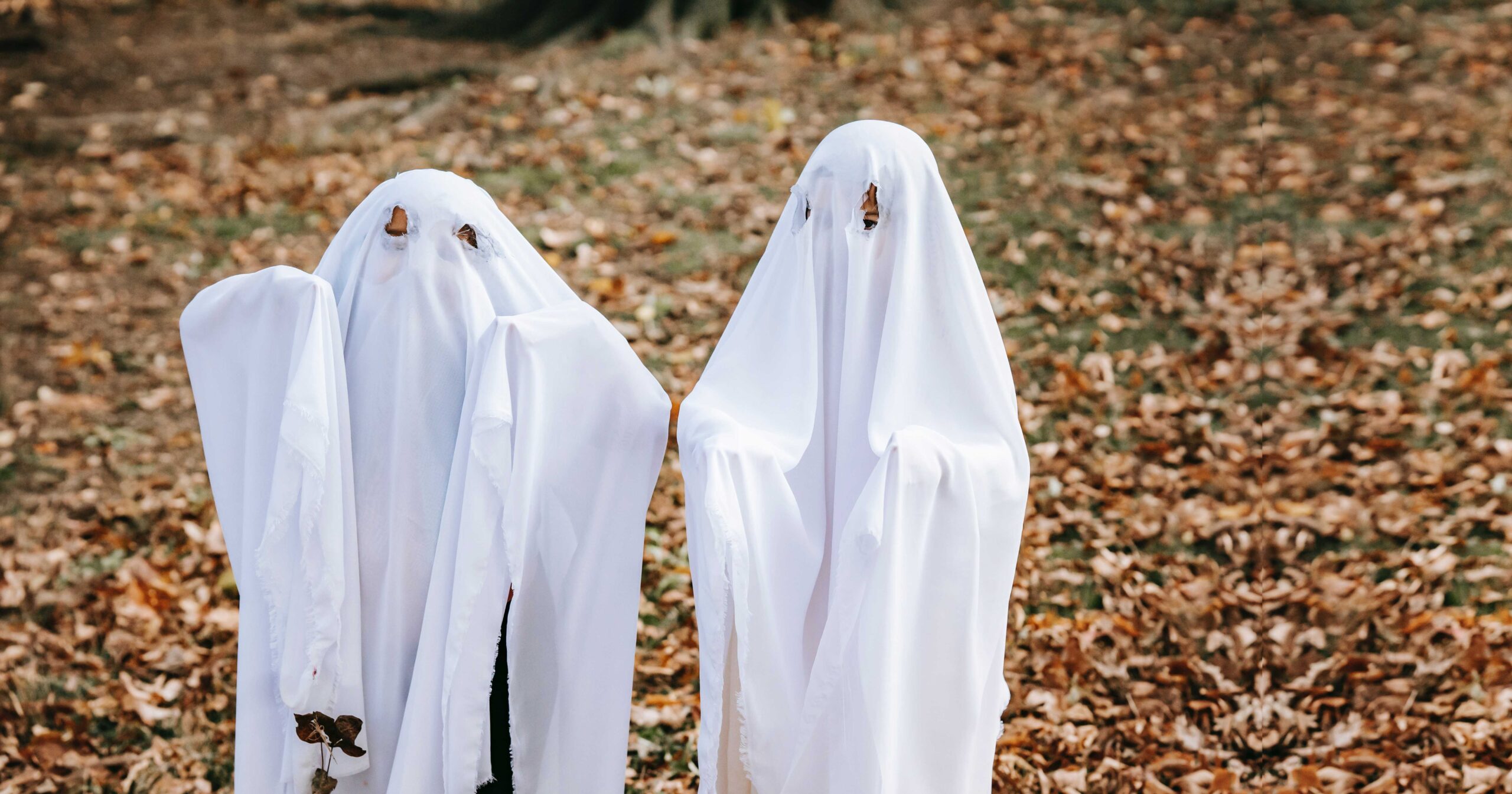 children dressed in sheets as ghosts